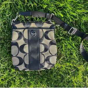 black and grey Coach purse with shoulder strap